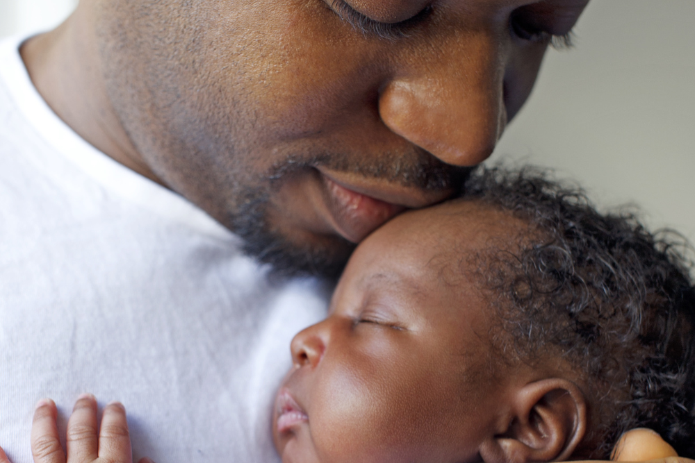 Dad kissing baby